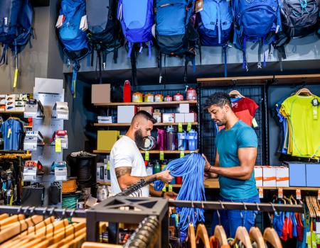 interior shot of an outdoor gear store with customer being helped by employee
