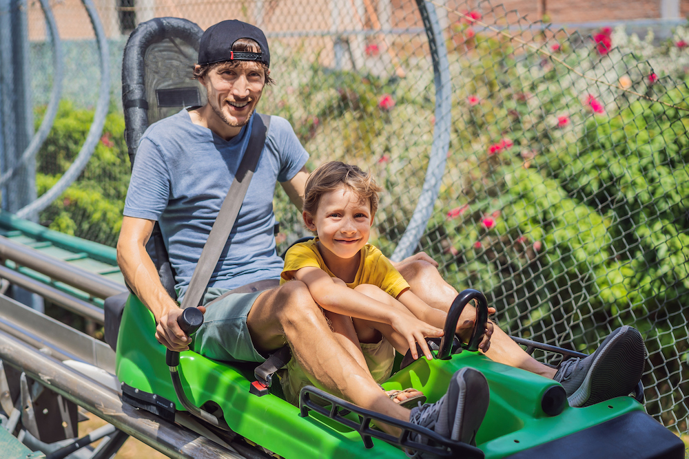 father and child on an alpine coaster