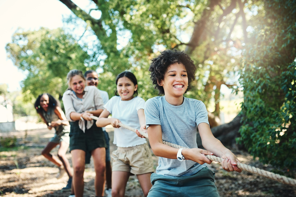 kids playing tug-of-war in the sunshine 
