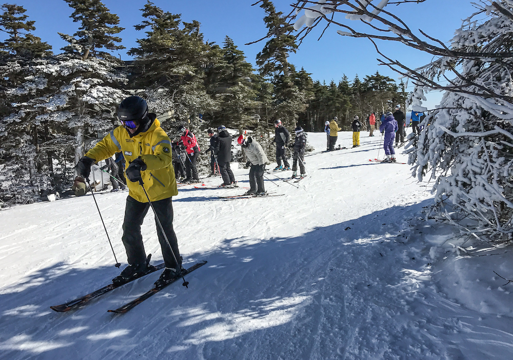 group of people skiing on a trail in vermont